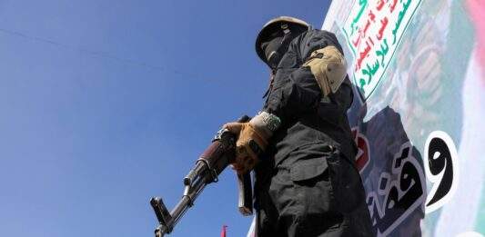 A Houthi Fighter Stands Guard During A Ceremony At The End Of The Training Of Newly Recruited Houthi Fighters In Sanaa