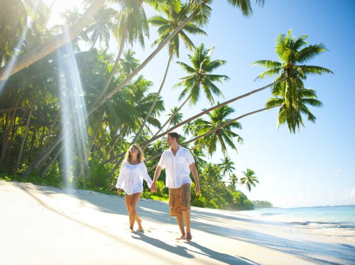 Young Couple Relaxing On An Idyllic Tropical Beach