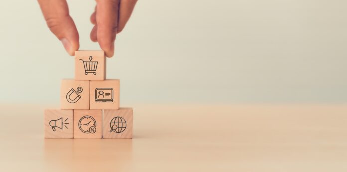 E commerce,business,strategy,concept.,hand,placing,a,wooden,block,with