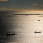 An aerial view shows cargo and tankers ships sailing in the Mediterranean sea in front of the port in Barcelona